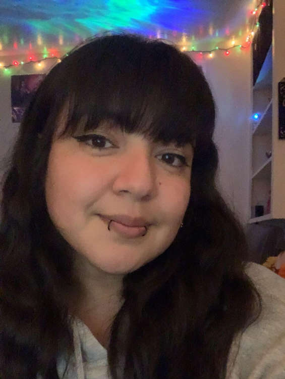 A selfie of a younger adult in a well-lit room