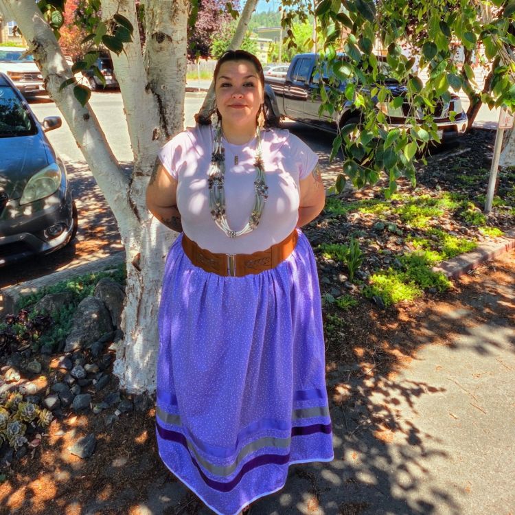 A native woman wearing regalia